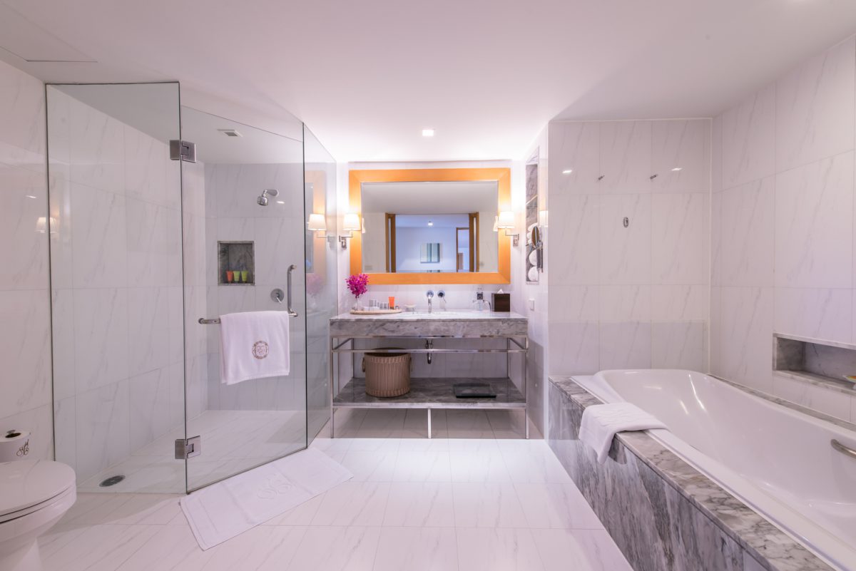 marble sink mirror bathtub on right side shower on left side
